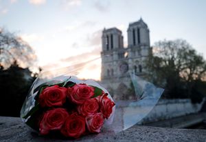 Un mazzo di fiori davanti a Notre-Dame ferita (Reuters)