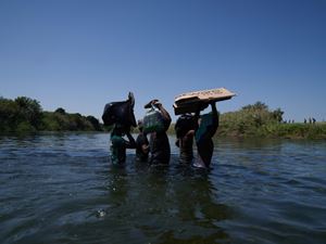 Un'altra immagine dei migranti durante il guado del fiume Del Rio. Una traversata pericolosa, non sono mancate, secondo le testimonianze, le vittime (foto ANSA)